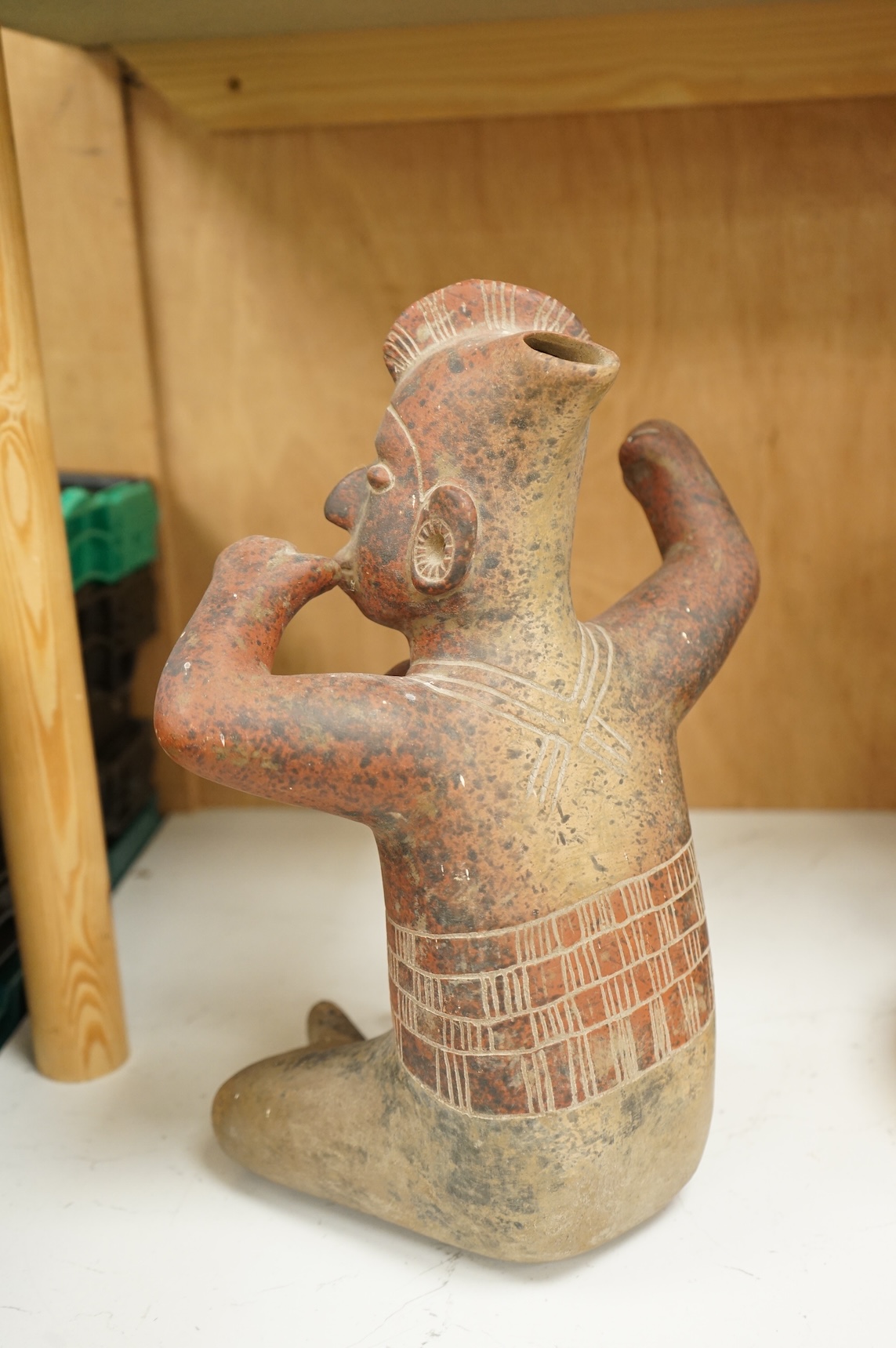 A terracotta pre-Columbian style warrior, over 60 years old, 34cm high